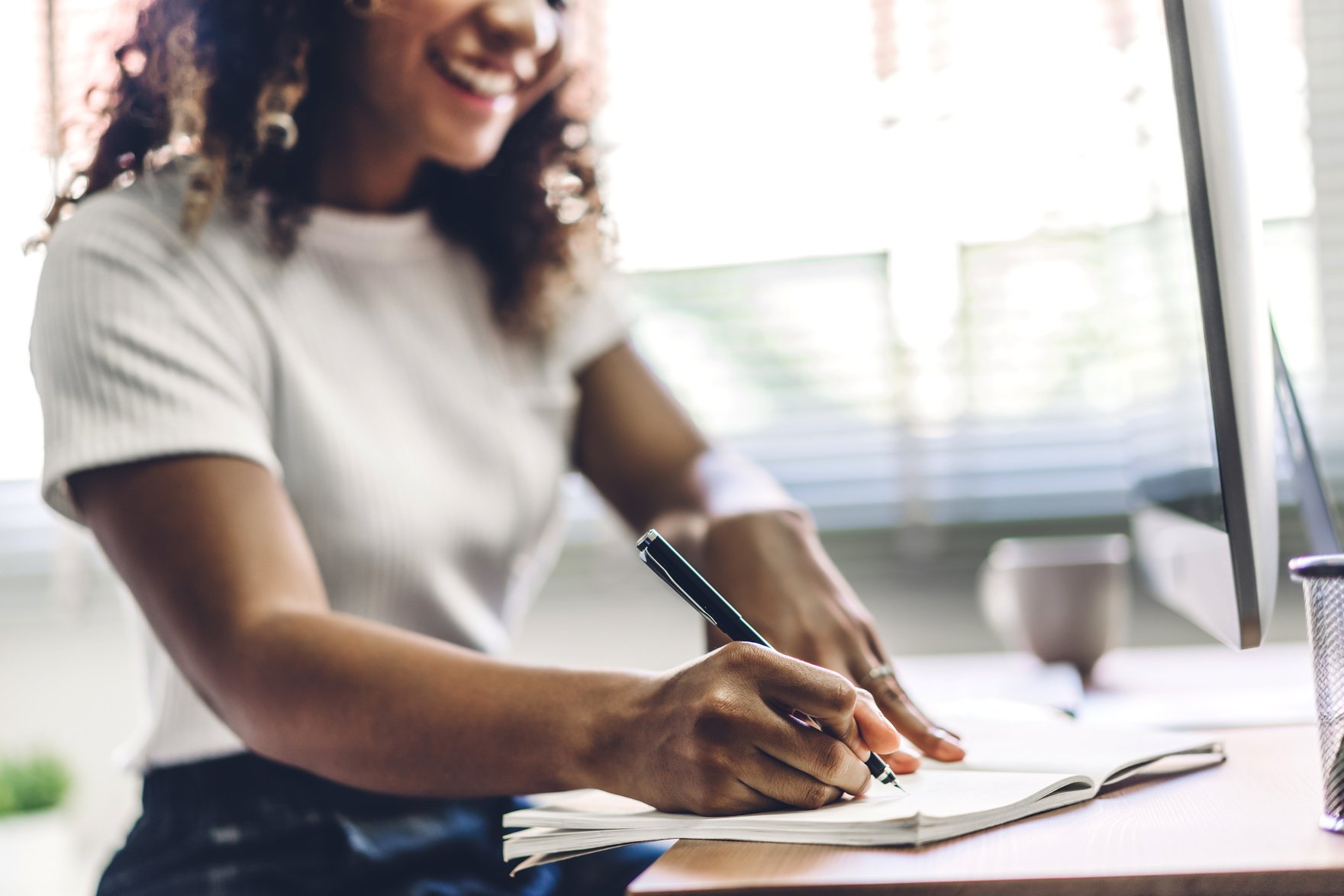 Woman Writing on Notebook